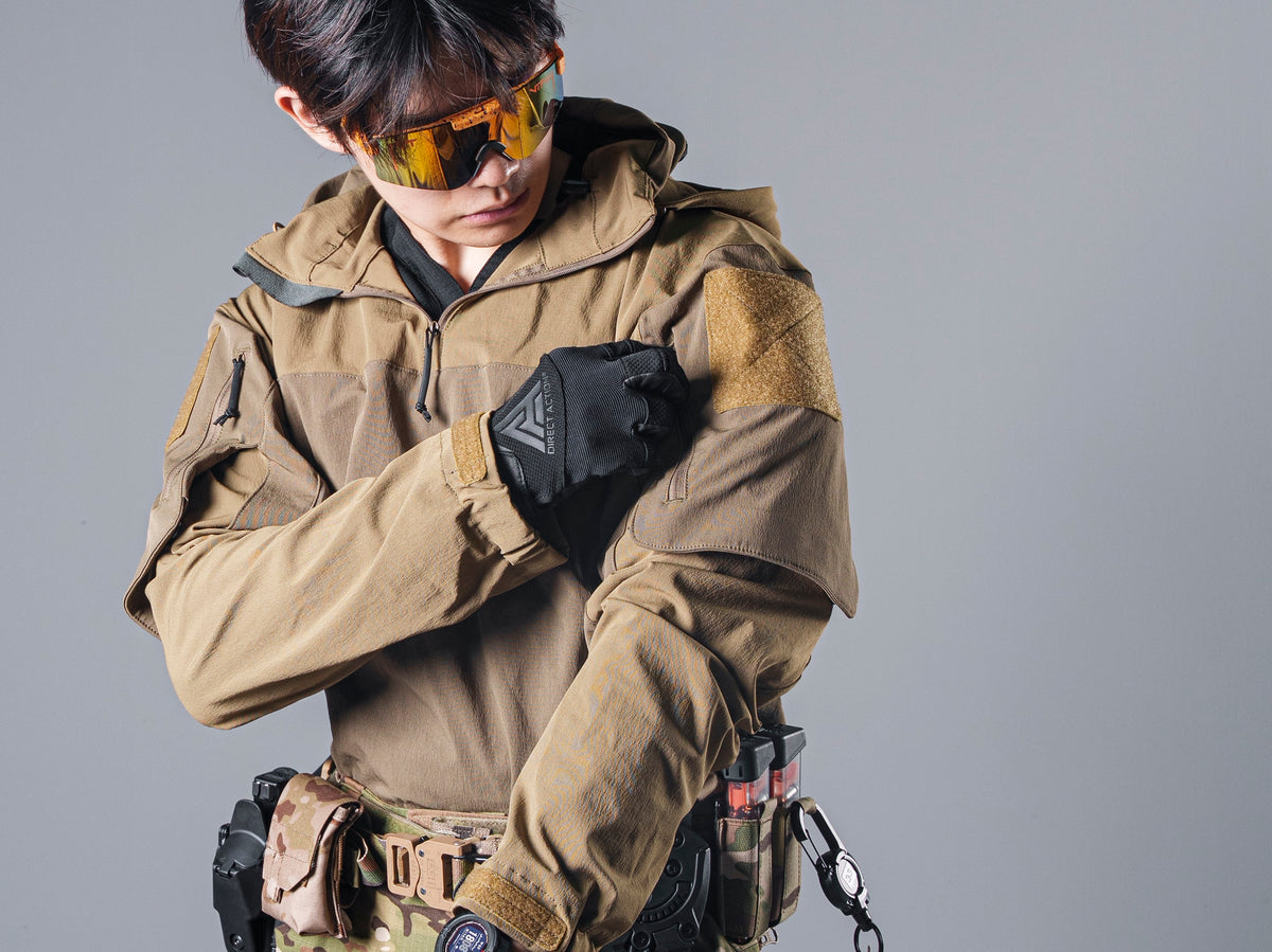 Close-up of the tan Gryphon Crocodile Halfshell Jacket sleeve and hook-and-loop patch as the model adjusts a glove.