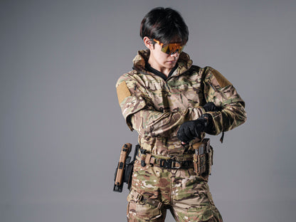 Model wearing the Multicam Gryphon Halfshell Jacket while adjusting a black glove at the wrist.