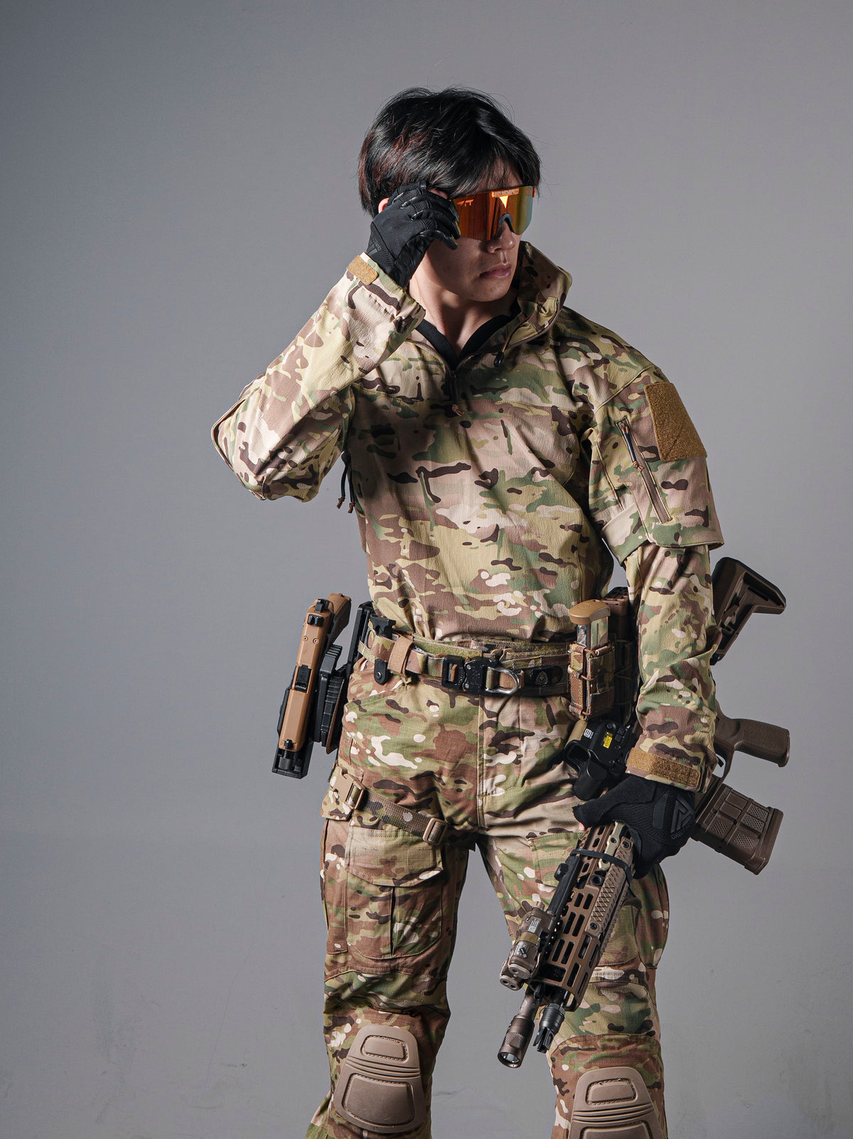 Model wearing the BKG ARC-style Gryphon Multicam Halfshell Jacket with matching camouflage trousers and tactical gear.