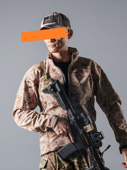 Model wearing the tan AOR1 digital camouflage BKG ARC-Style LEAF Minotaur full-zip softshell jacket while holding a rifle.