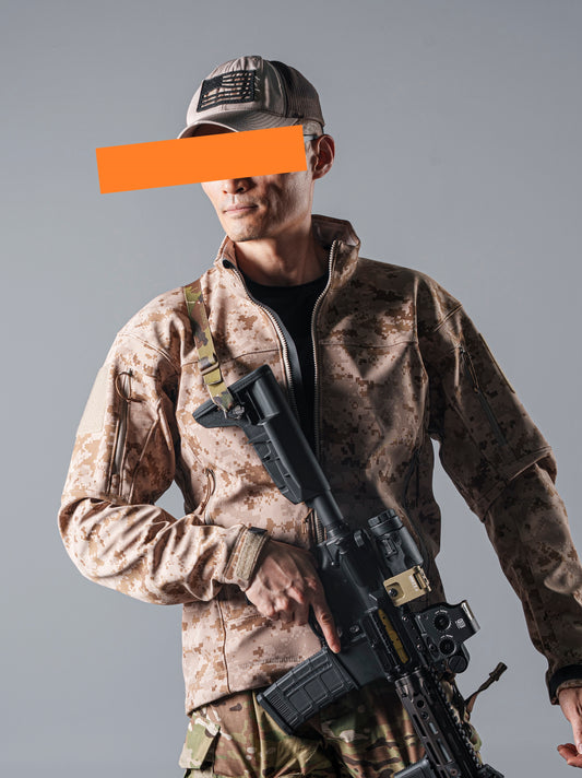 Model wearing the tan AOR1 digital camouflage BKG ARC-Style LEAF Minotaur full-zip softshell jacket while holding a rifle.