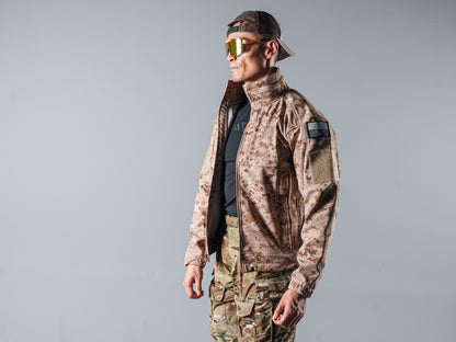 Side view of a model wearing the tan AOR1 Cold Fusion softshell jacket partly open over a black shirt.
