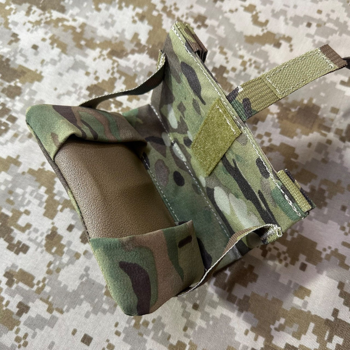 Open view of the Multicam Garmin M650 GPS flip pouch showing its tan interior and closure straps.